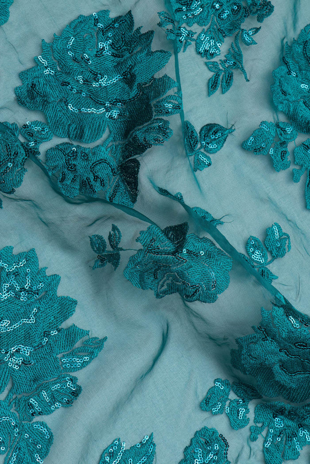Close up of Green Blended Organza Silk Saree with Embroidery on the body and Embroidery Border.  displaying folds