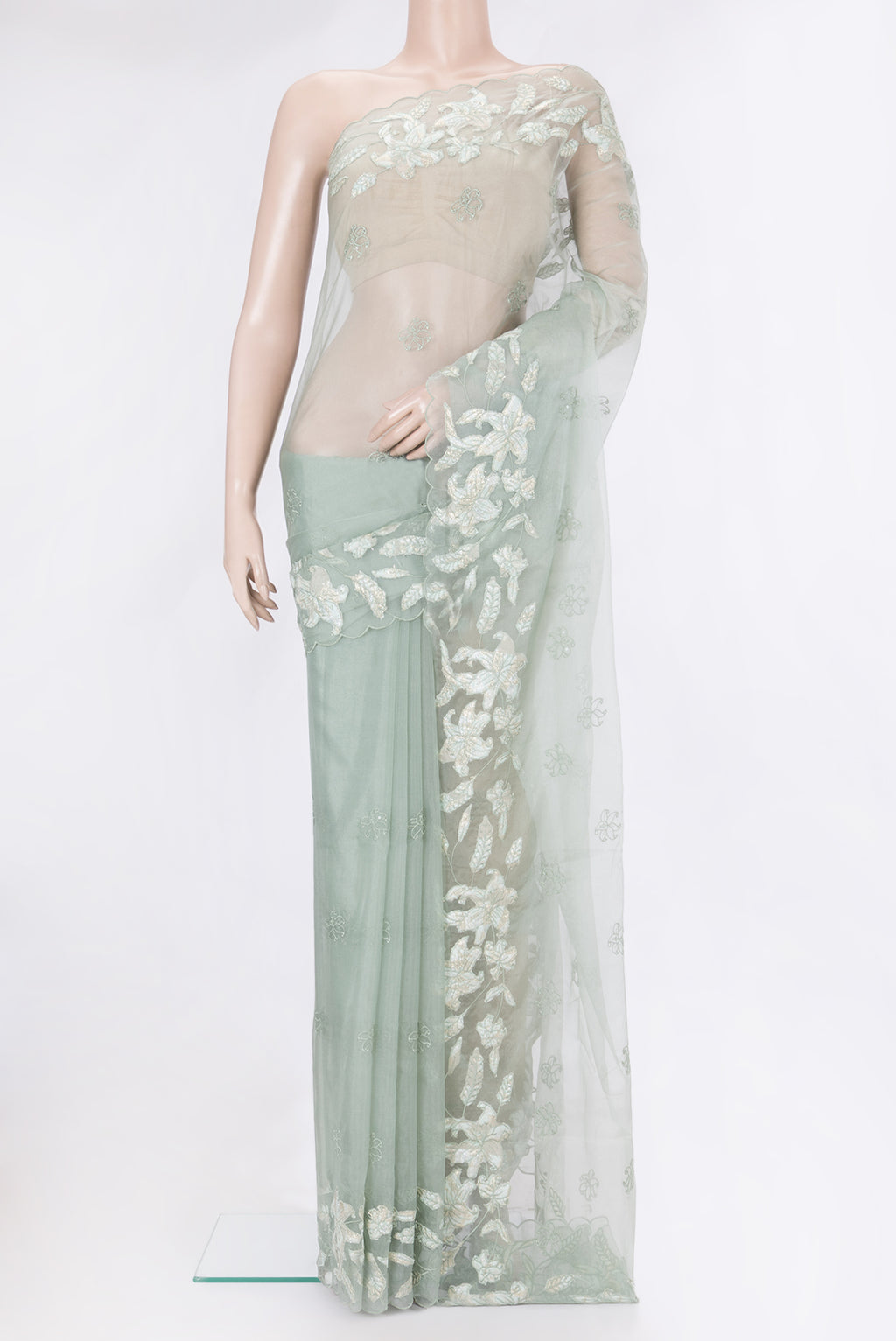 Light Green Organza Silk Saree with Embroidery on the body and Embroidery Border.  displayed on a mannequin