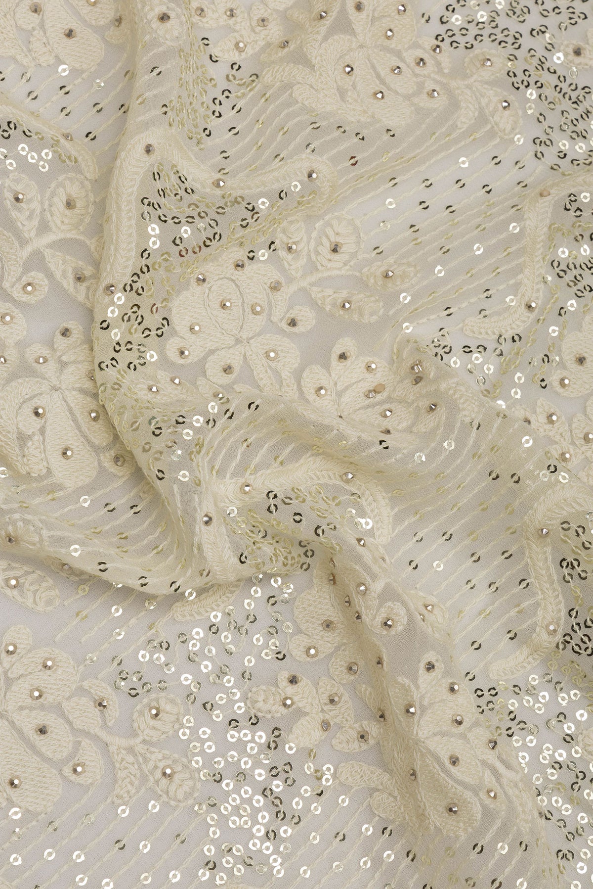 Close up of Off White Dual Tone Georgette Saree with Embroidery on the body and Sequin Border.  displaying folds