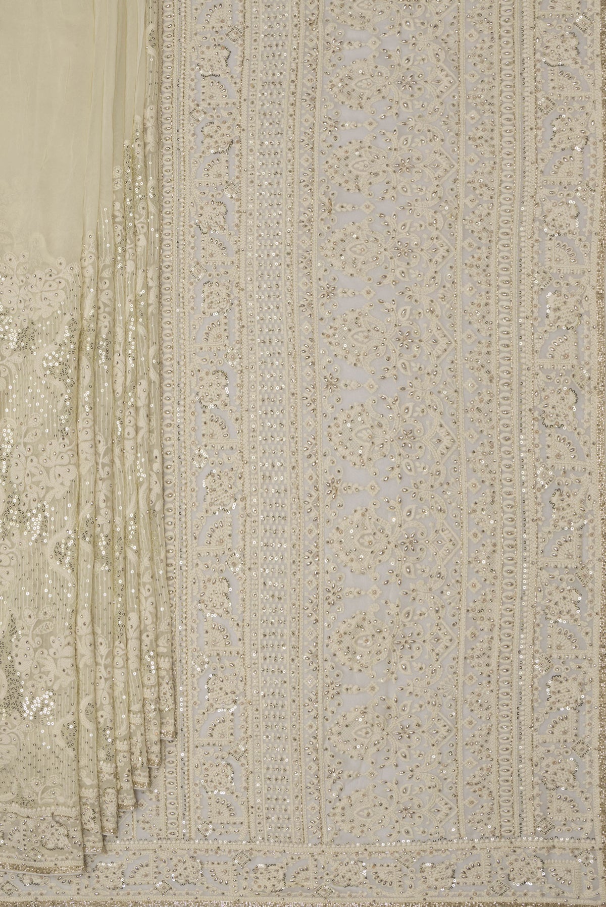 Pleats and pallu of Off White Dual Tone Georgette Saree with Embroidery on the body and Sequin Border. 