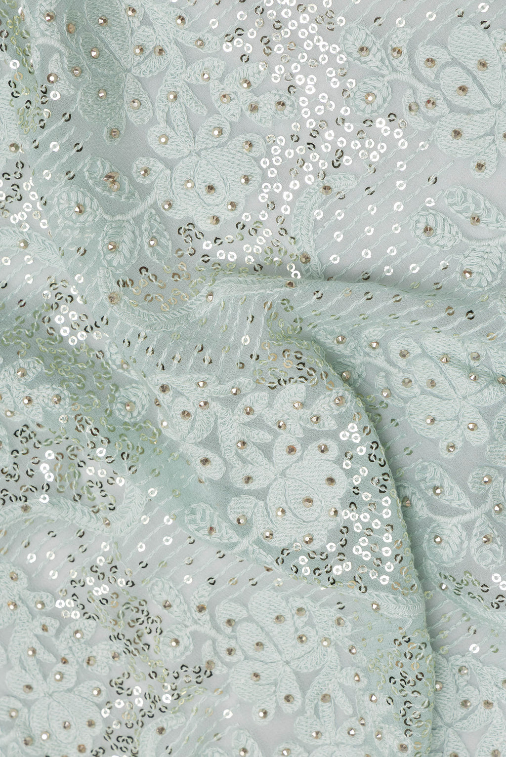 Close up of Light Blue Dual Tone Georgette Saree with Embroidery on the body and Sequin Border.  displaying folds