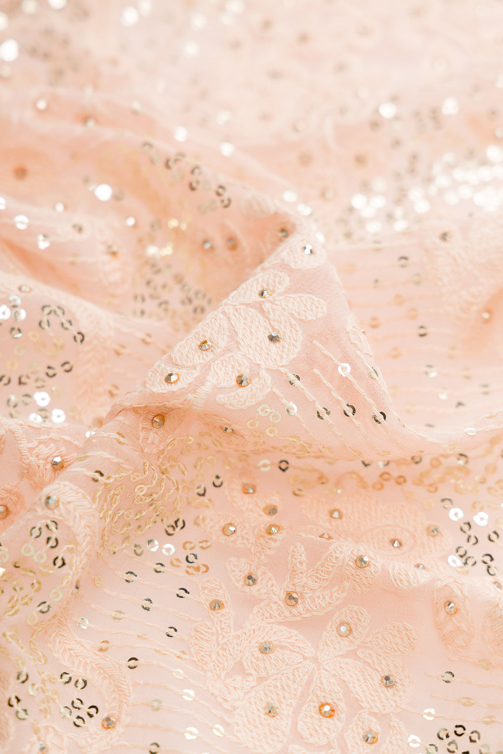 Close up of Peach Dual Tone Mysore Georgette Saree with Embroidered on the body and Sequin Border.  displaying folds