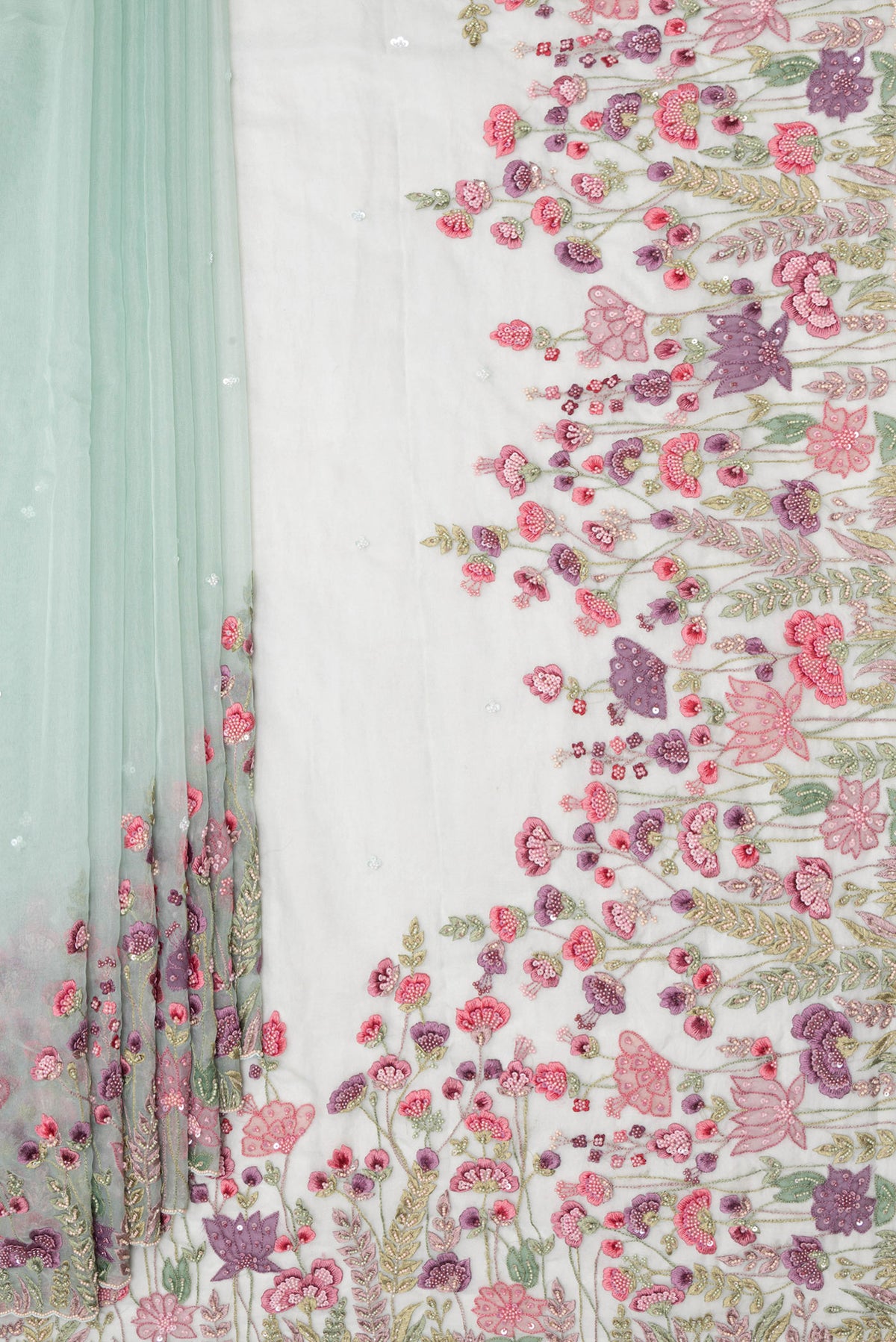 Pleats and pallu of Pure Silk Light Green Dual Tone Organza Saree with Embroidery on the body and Sequin Border. 