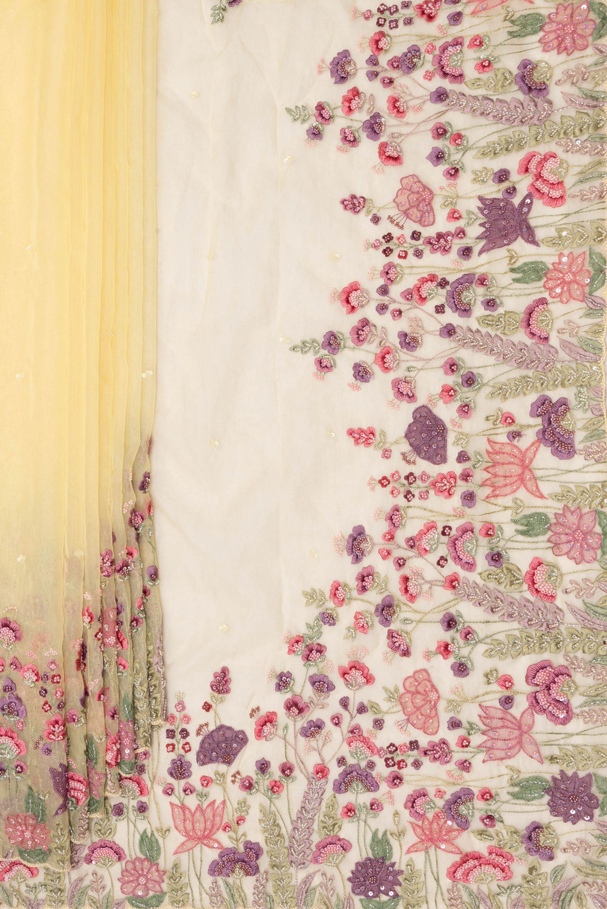Pleats and pallu of Lemon Yellow Organza Saree with Embroidered on the body and Embroidered Border. 