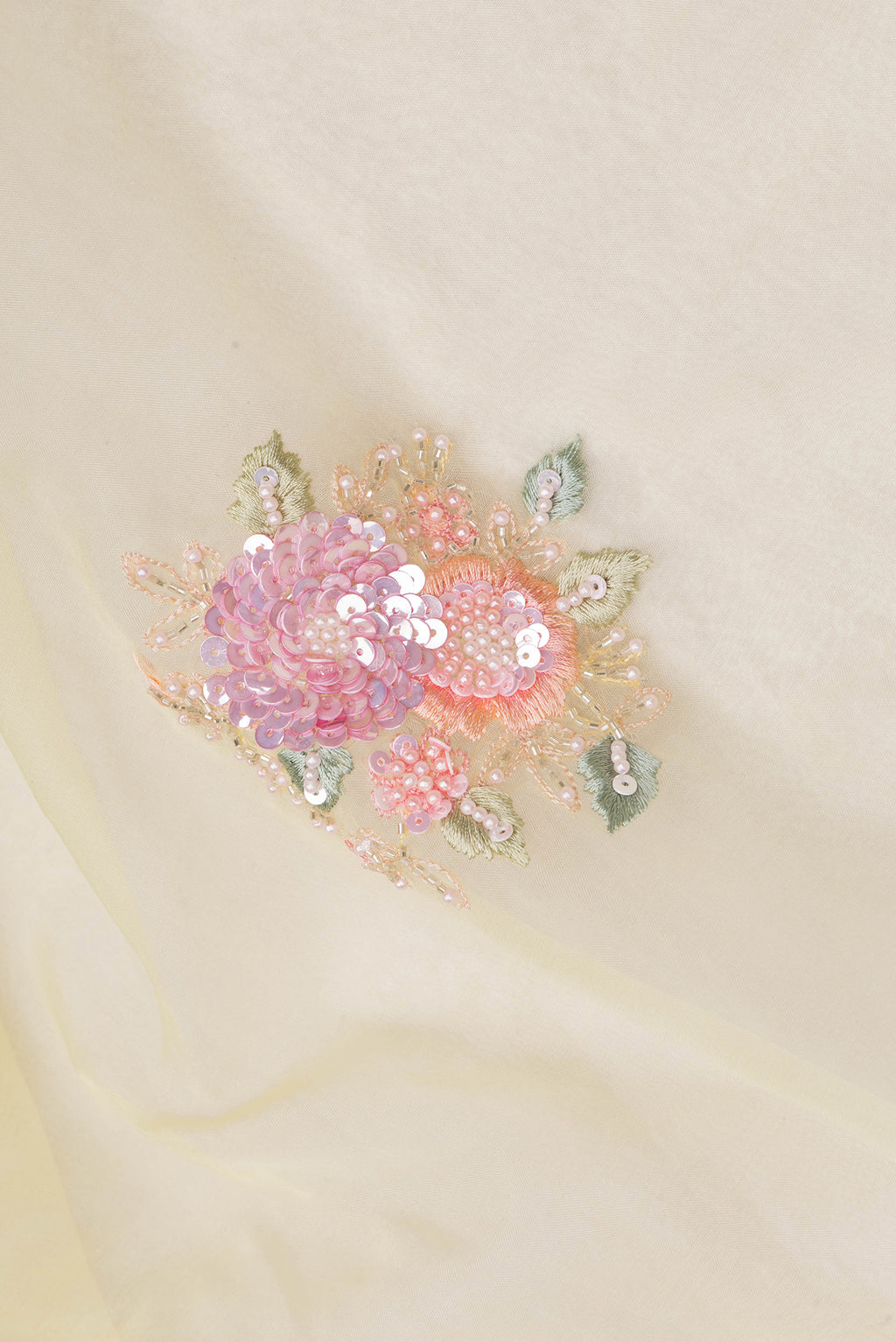 Close up of Lemon Yellow Organza Saree with Embroidered on the body and Sequin Border.  displaying folds