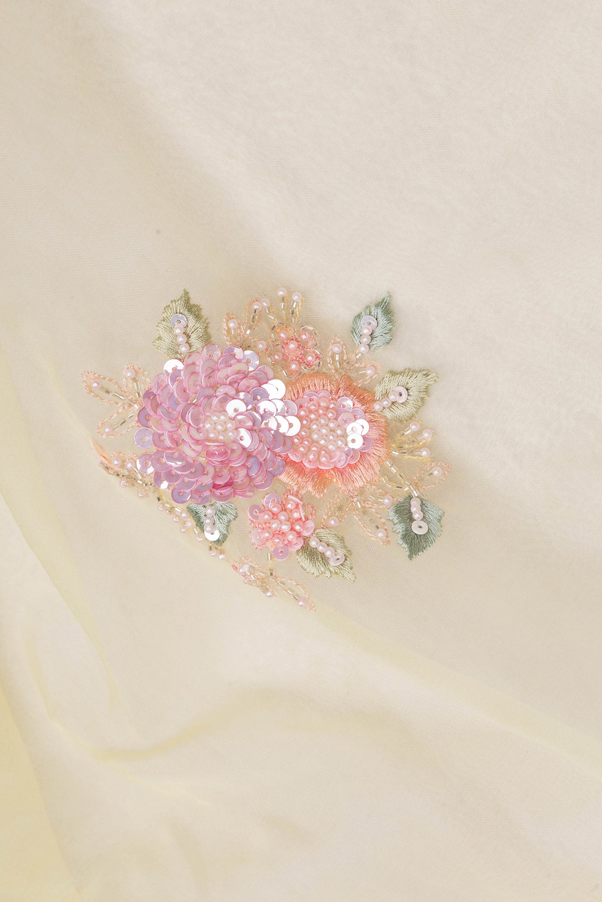 Close up of Lemon Yellow Organza Saree with Embroidered on the body and Sequin Border.  displaying folds