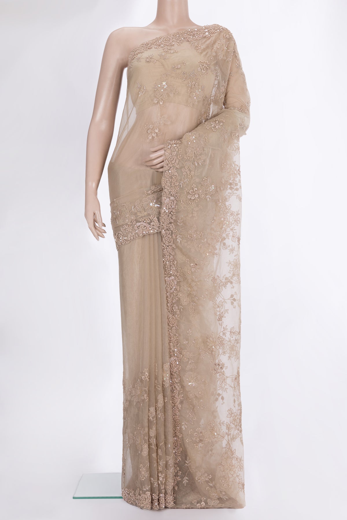 Beige Organza Saree with Embroidered on the body and Sequin Border.  displayed on a mannequin