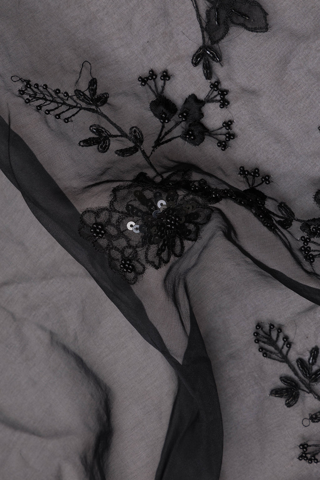 Close up of Pure Silk Black Organza Saree with Embroidered on the body and Embroidered Border.  displaying folds