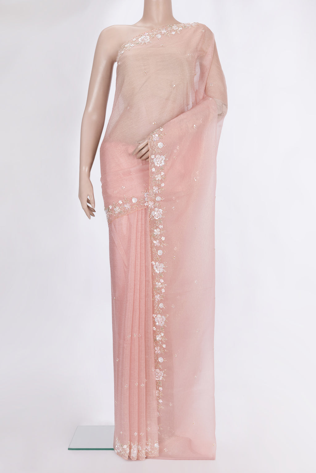 Peach Organza Saree with Embroidered on the body and Sequin Border.  displayed on a mannequin