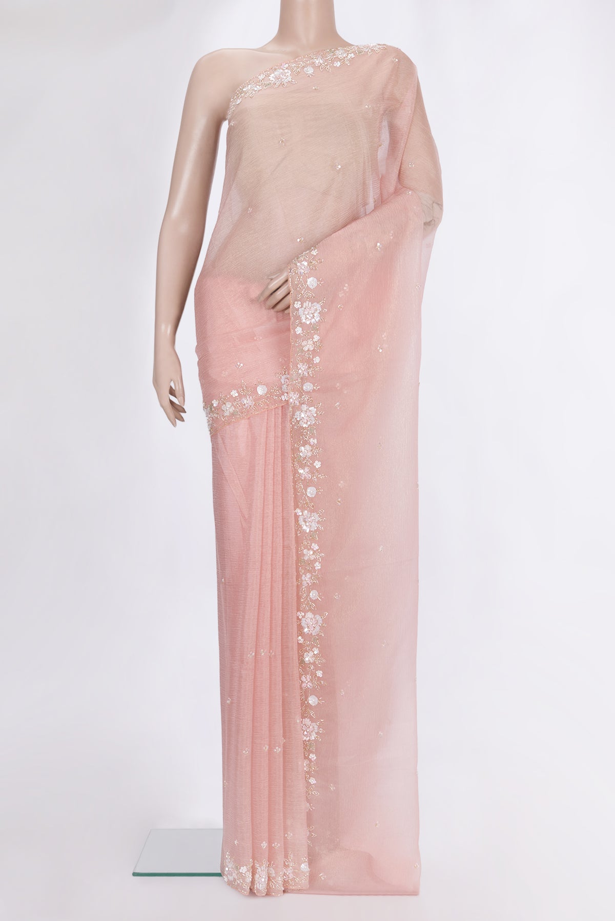 Peach Organza Saree with Embroidered on the body and Sequin Border.  displayed on a mannequin