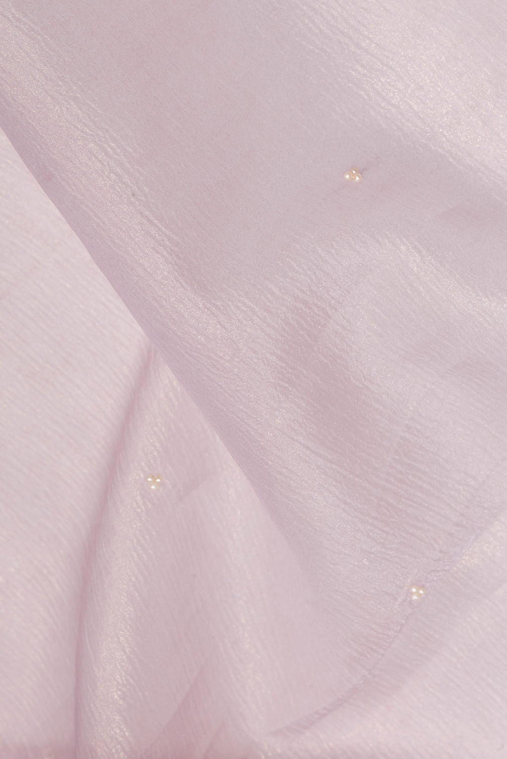 Close up of Lavender Dual Tone Organza Saree with Embroidered on the body and Embroidered Border.  displaying folds
