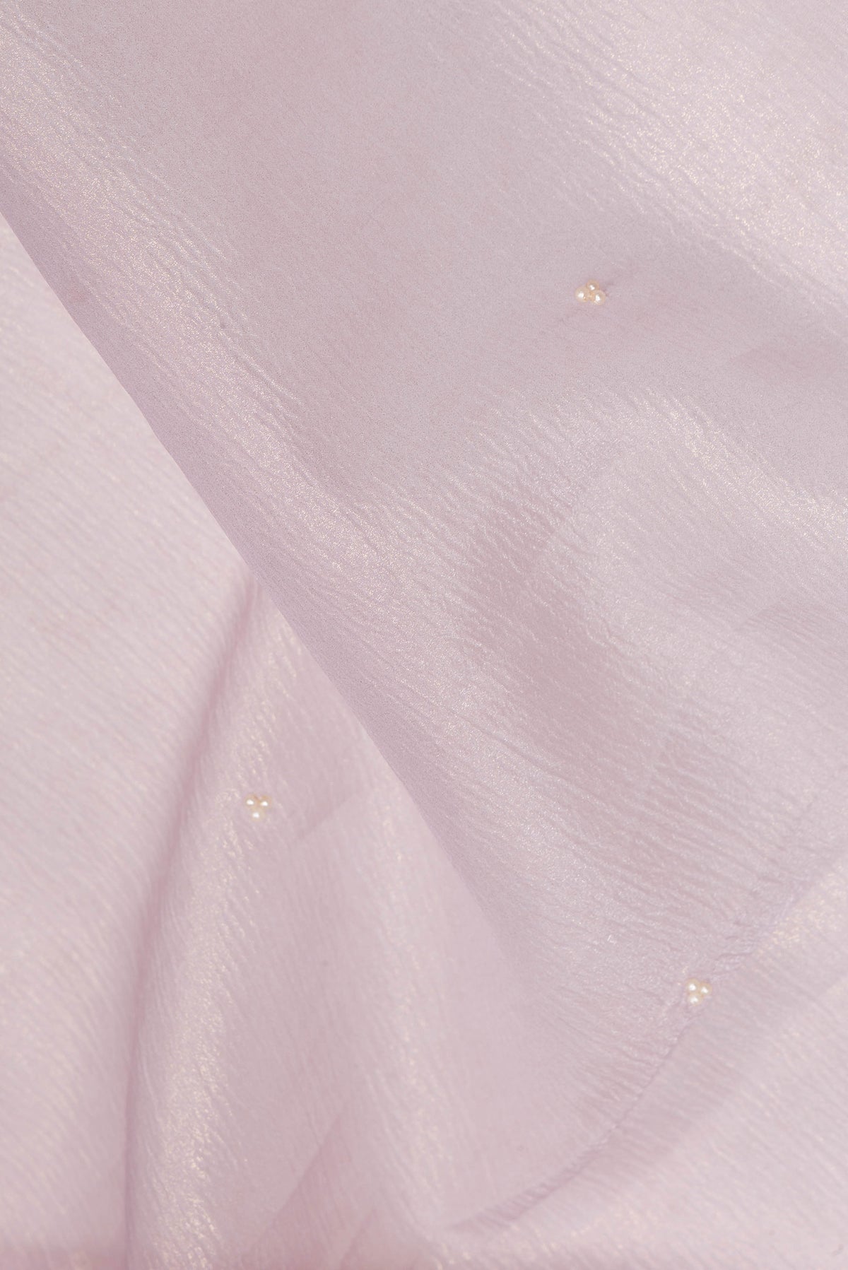 Close up of Lavender Dual Tone Organza Saree with Embroidered on the body and Embroidered Border.  displaying folds
