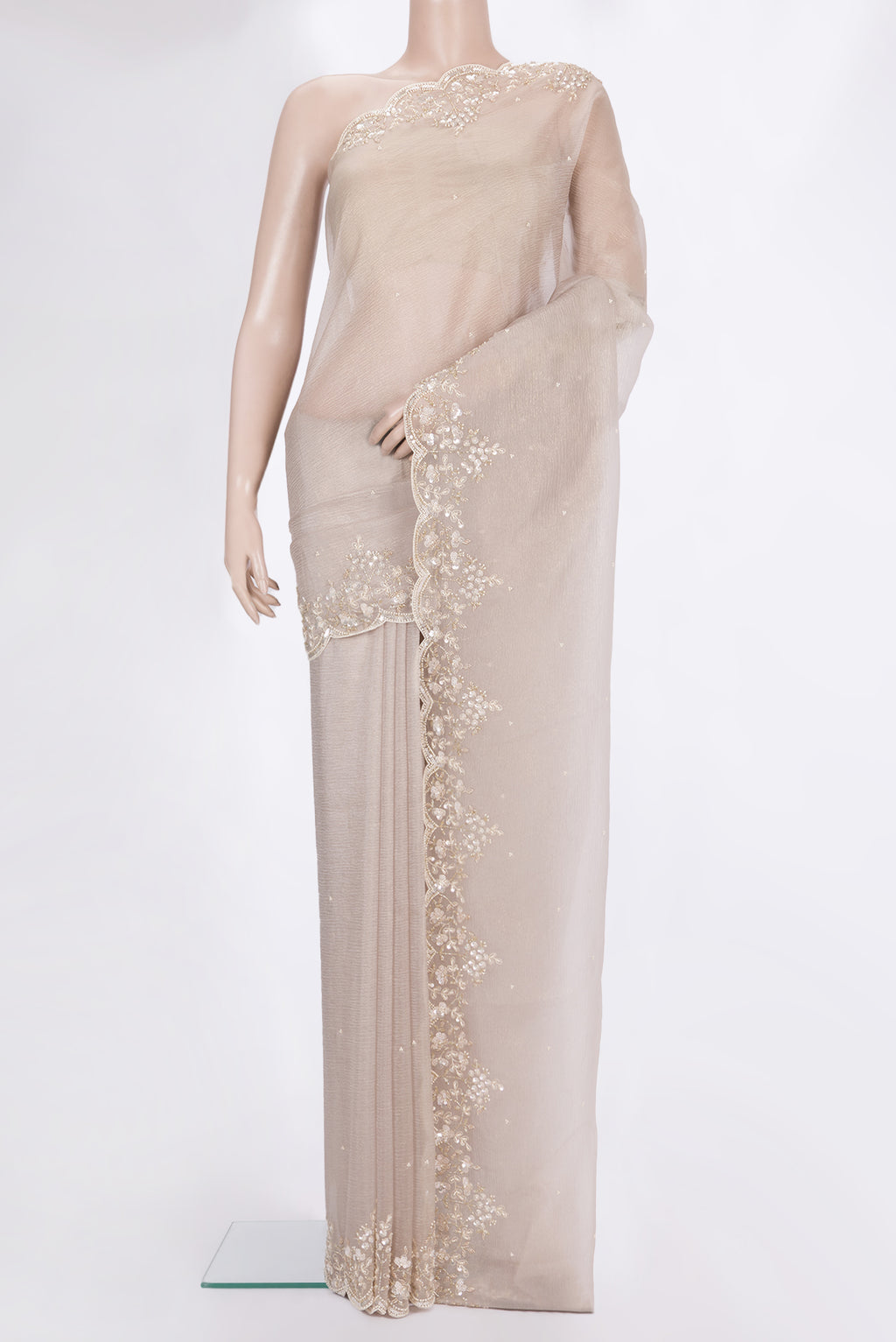 Beige Organza Saree with Embroidered on the body and Embroidered Border.  displayed on a mannequin