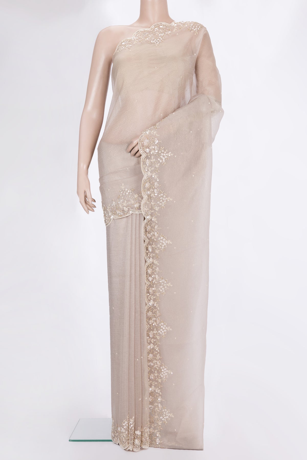 Beige Organza Saree with Embroidered on the body and Embroidered Border.  displayed on a mannequin