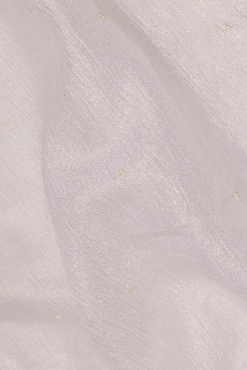 Close up of Off White Organza Saree with Embroidered on the body and Embroidered Border.  displaying folds