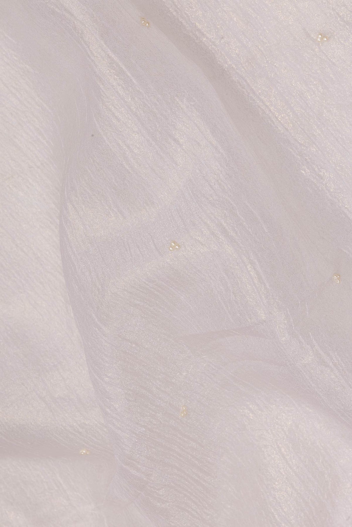 Close up of Off White Organza Saree with Embroidered on the body and Embroidered Border.  displaying folds