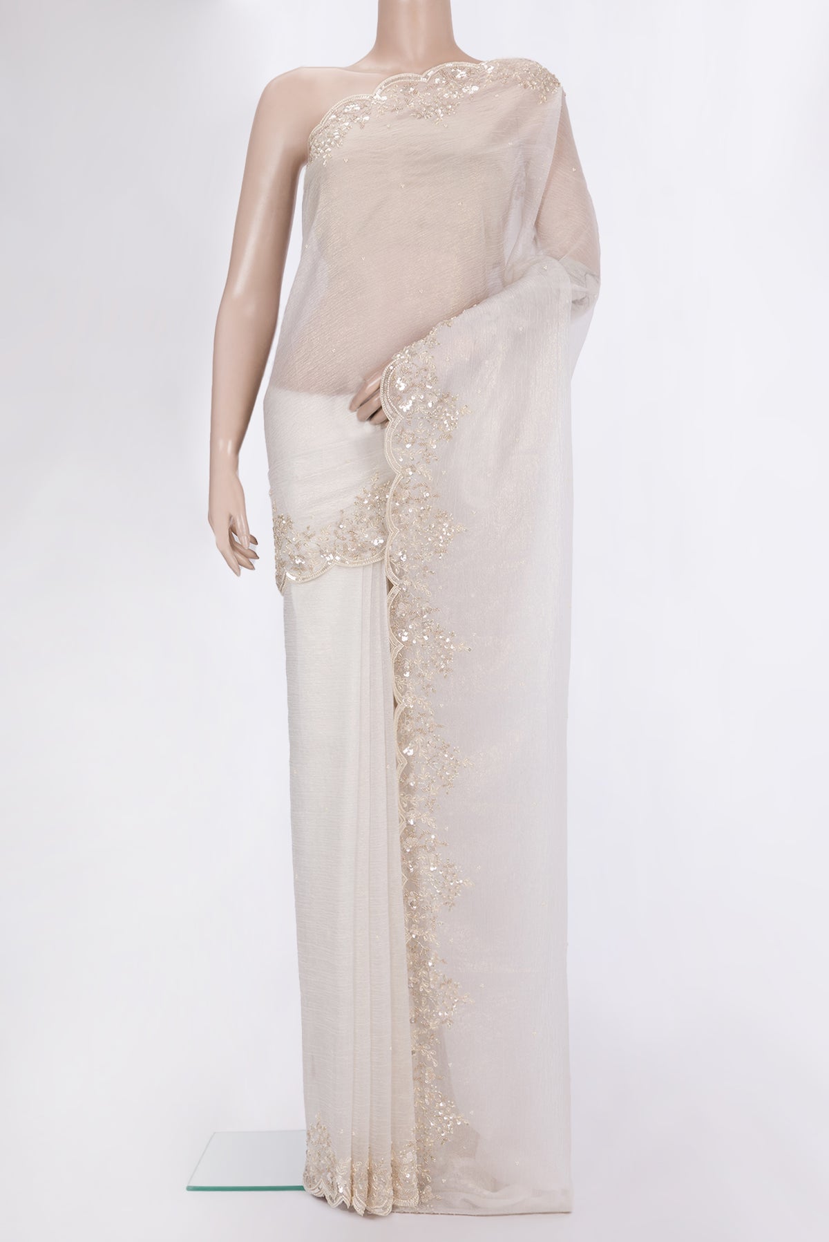 Off White Organza Saree with Embroidered on the body and Embroidered Border.  displayed on a mannequin