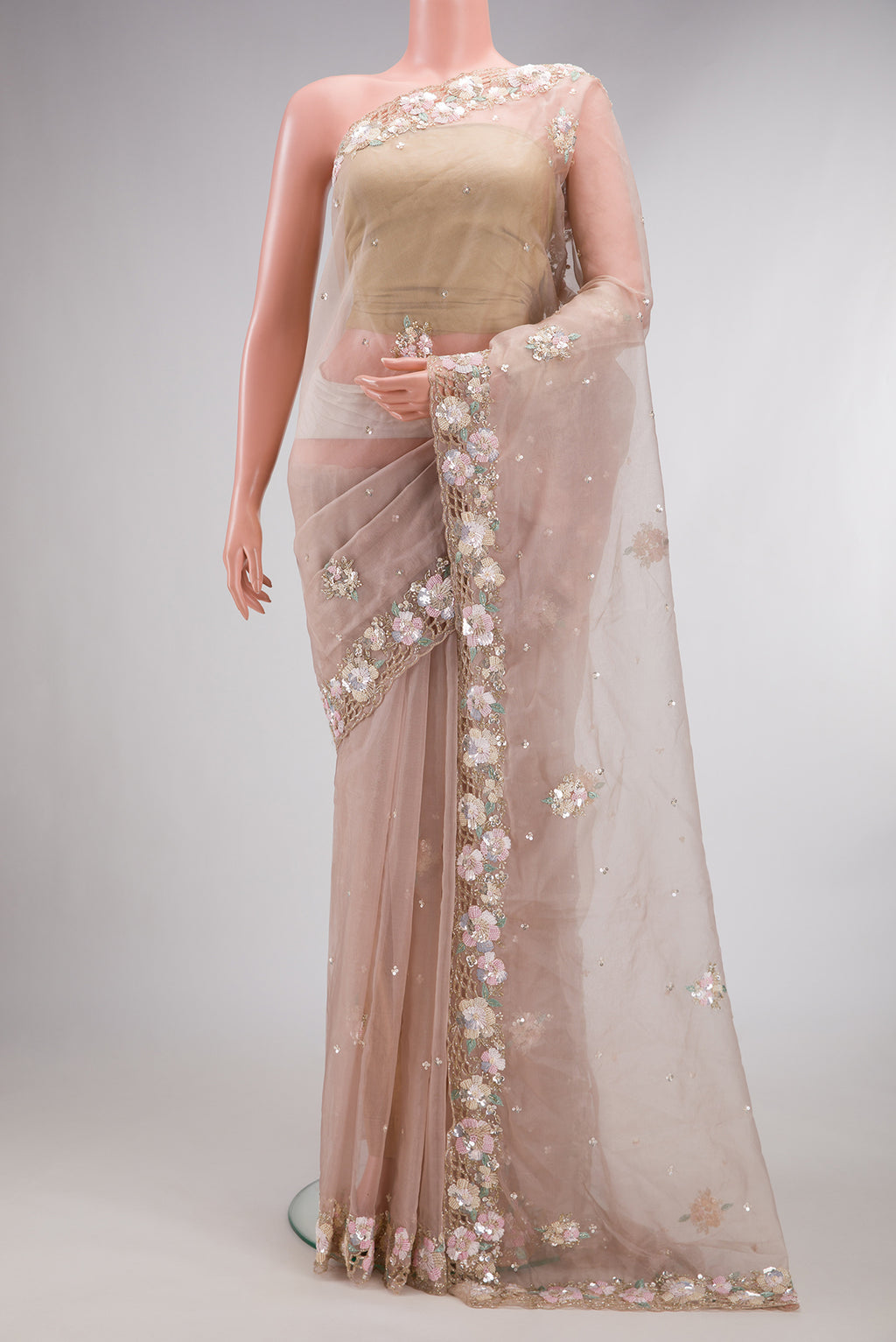 Rose Gold Organza Saree with Embroidered on the body and Sequin Border.  displayed on a mannequin