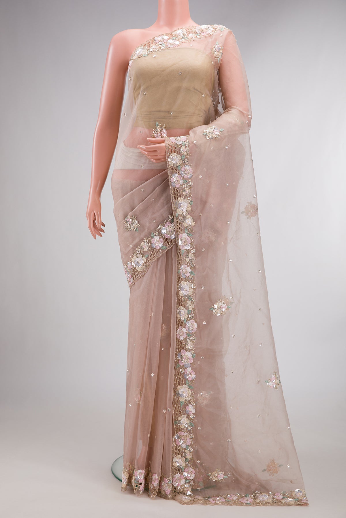 Rose Gold Organza Saree with Embroidered on the body and Sequin Border.  displayed on a mannequin