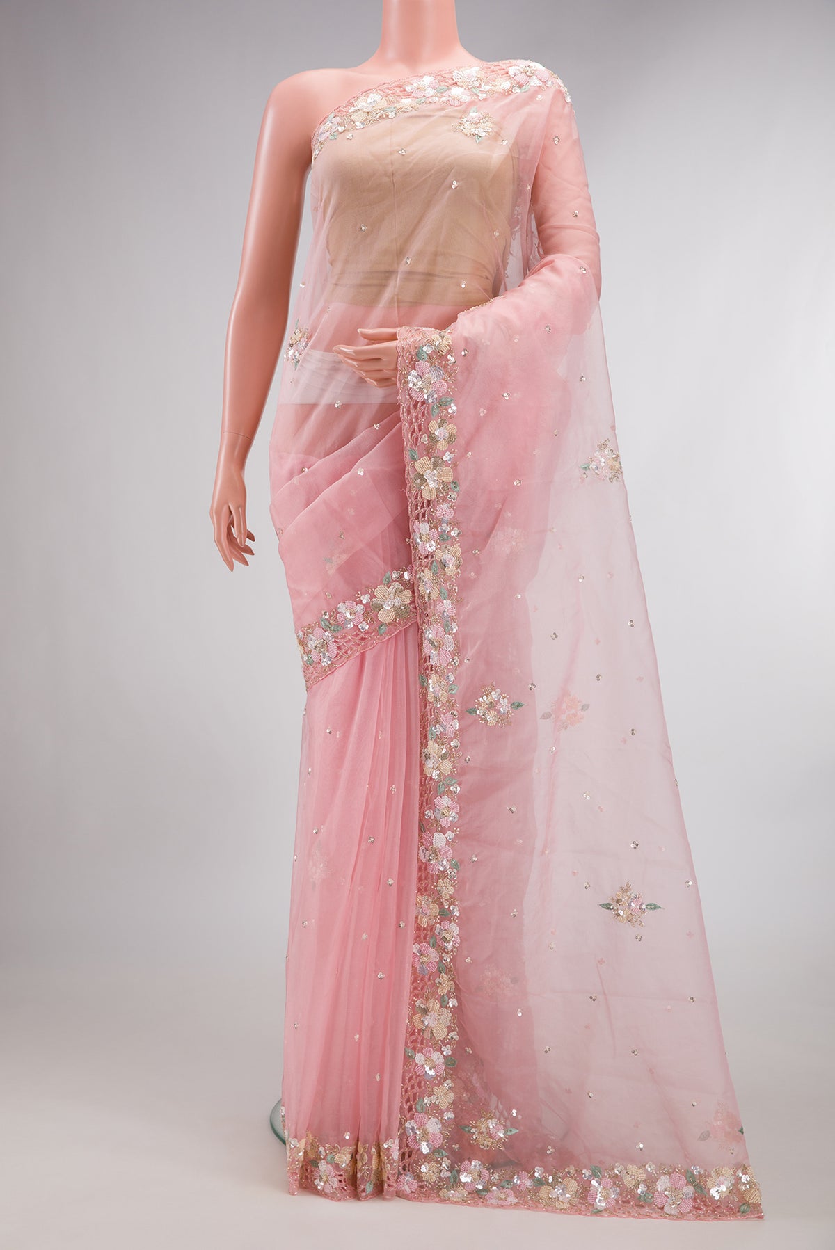 Pink Organza Saree with Embroidered on the body and Embroidered Border.  displayed on a mannequin