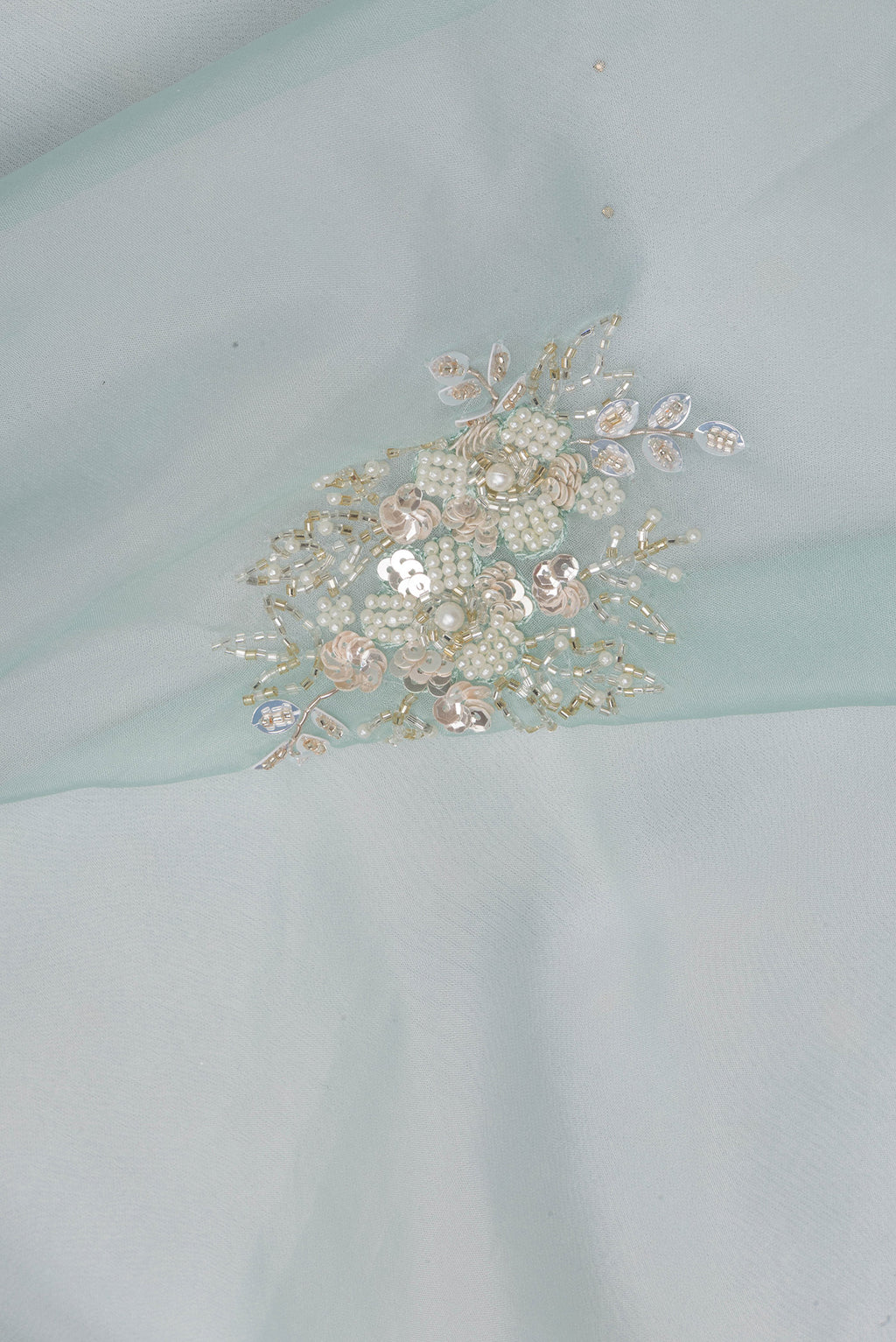 Close up of Pure Silk Light Blue Dual Tone Organza Saree with Embroidery on the body and Sequin Border.  displaying folds