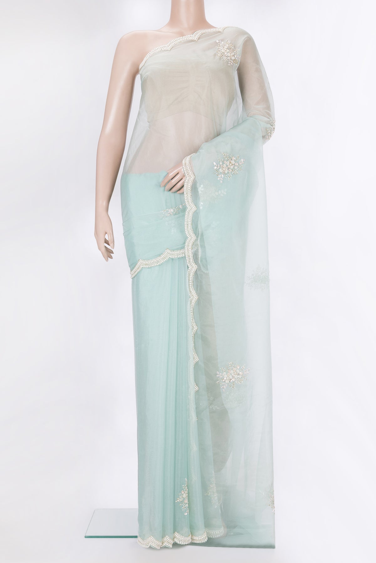 Pure Silk Light Blue Dual Tone Organza Saree with Embroidery on the body and Sequin Border.  displayed on a mannequin