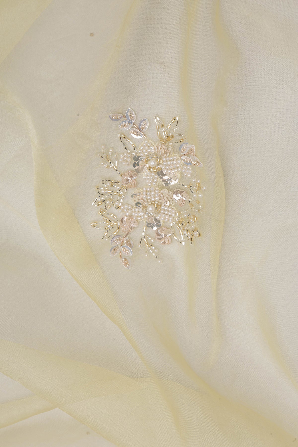 Close up of Pure Silk Sandal Dual Tone Organza Saree with Embroidery on the body and Sequin Border.  displaying folds