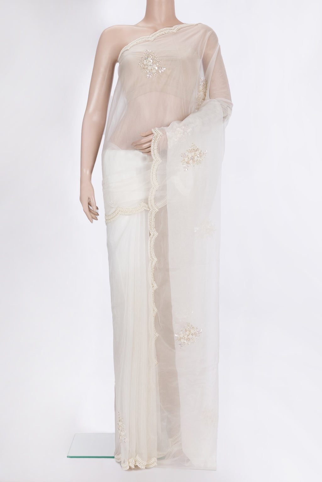 Off White Organza Saree with Embroidered on the body and Embroidered Border.  displayed on a mannequin