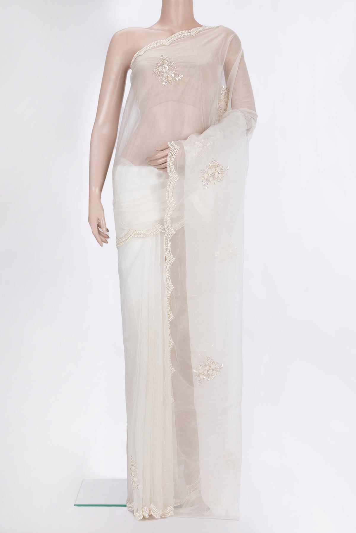 Off White Organza Saree with Embroidered on the body and Embroidered Border.  displayed on a mannequin