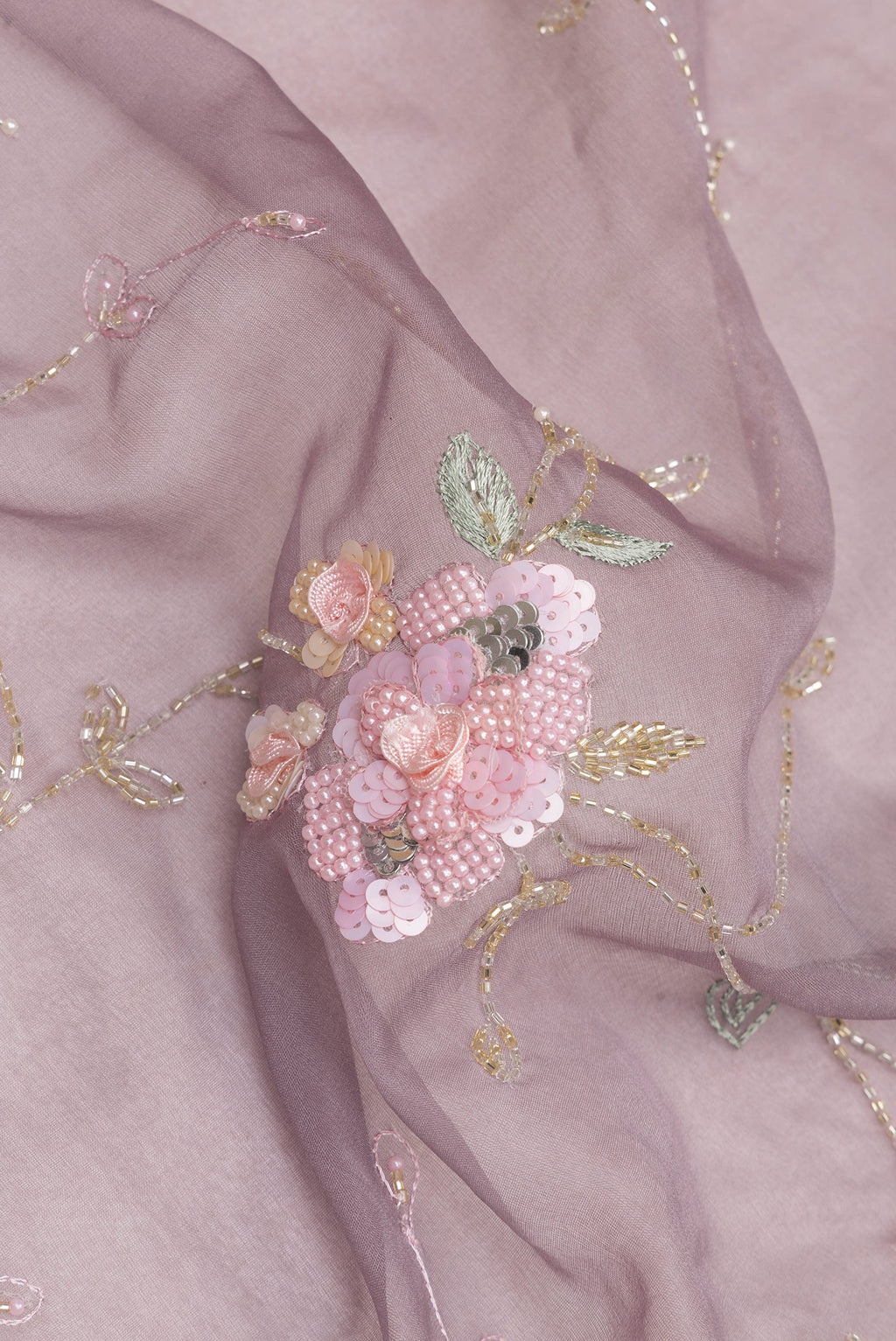 Close up of Grey Organza Saree with Embroidered on the body and Sequin Border.  displaying folds