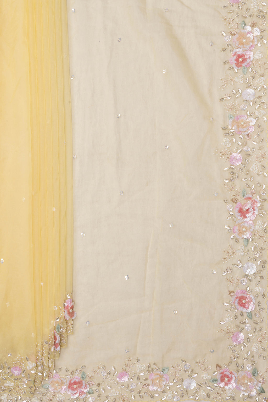 Pleats and pallu of Lemon Yellow Organza Saree with Embroidered on the body and Sequin Border. 