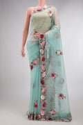 Light Blue Organza Saree with Embroidered on the body and Sequin Border.  displayed on a mannequin