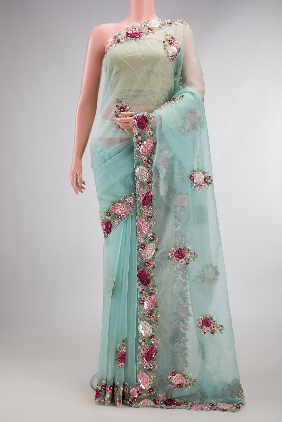 Light Blue Organza Saree with Embroidered on the body and Sequin Border.  displayed on a mannequin