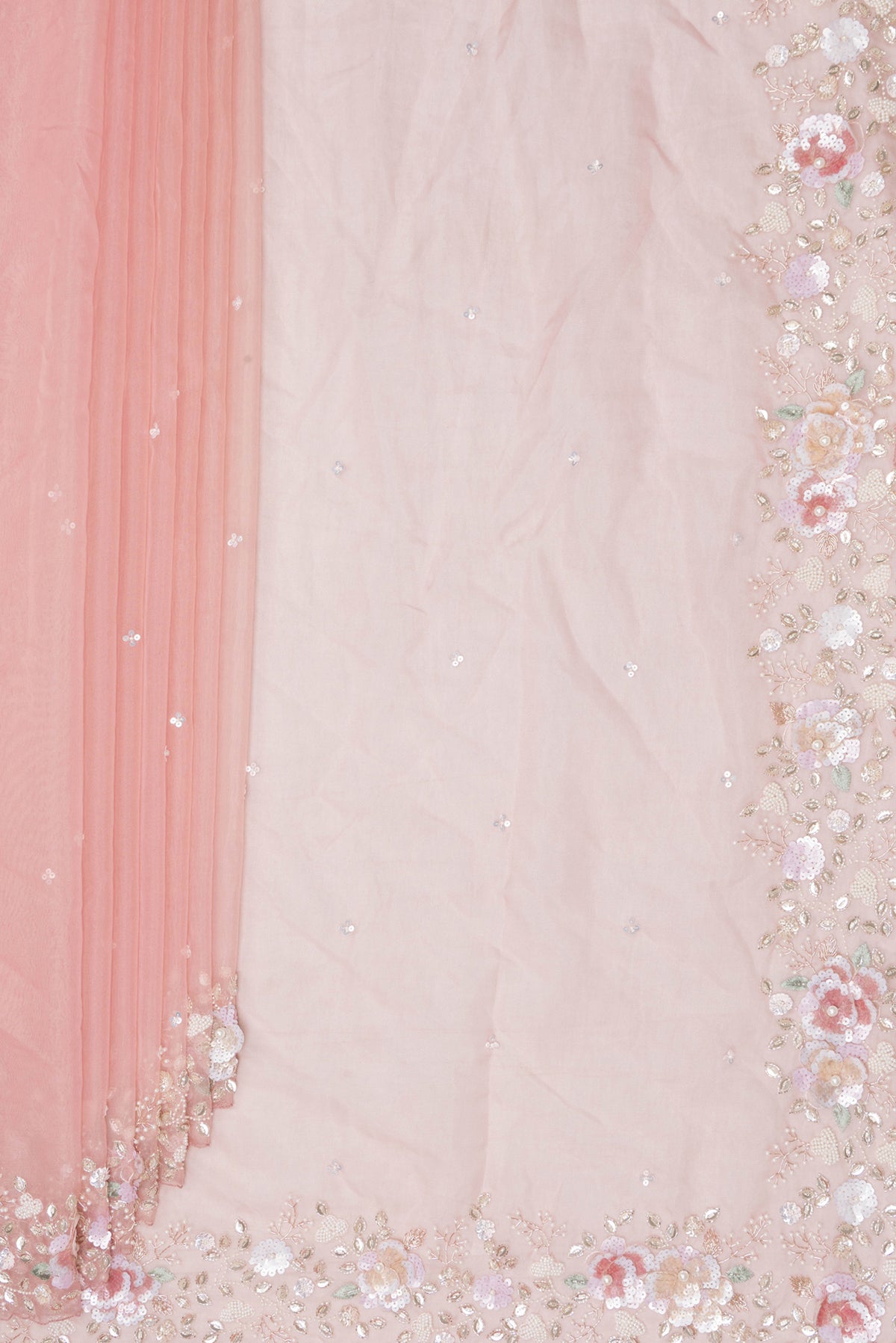 Pleats and pallu of Peach Organza Saree with Embroidered on the body and Sequin Border. 