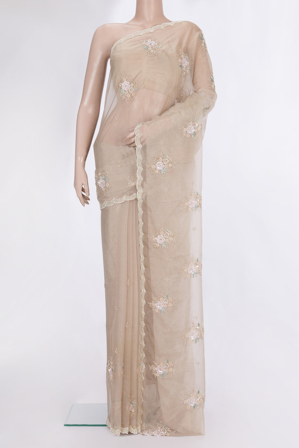 Beige Organza Saree with Embroidered on the body and Sequin Border.  displayed on a mannequin
