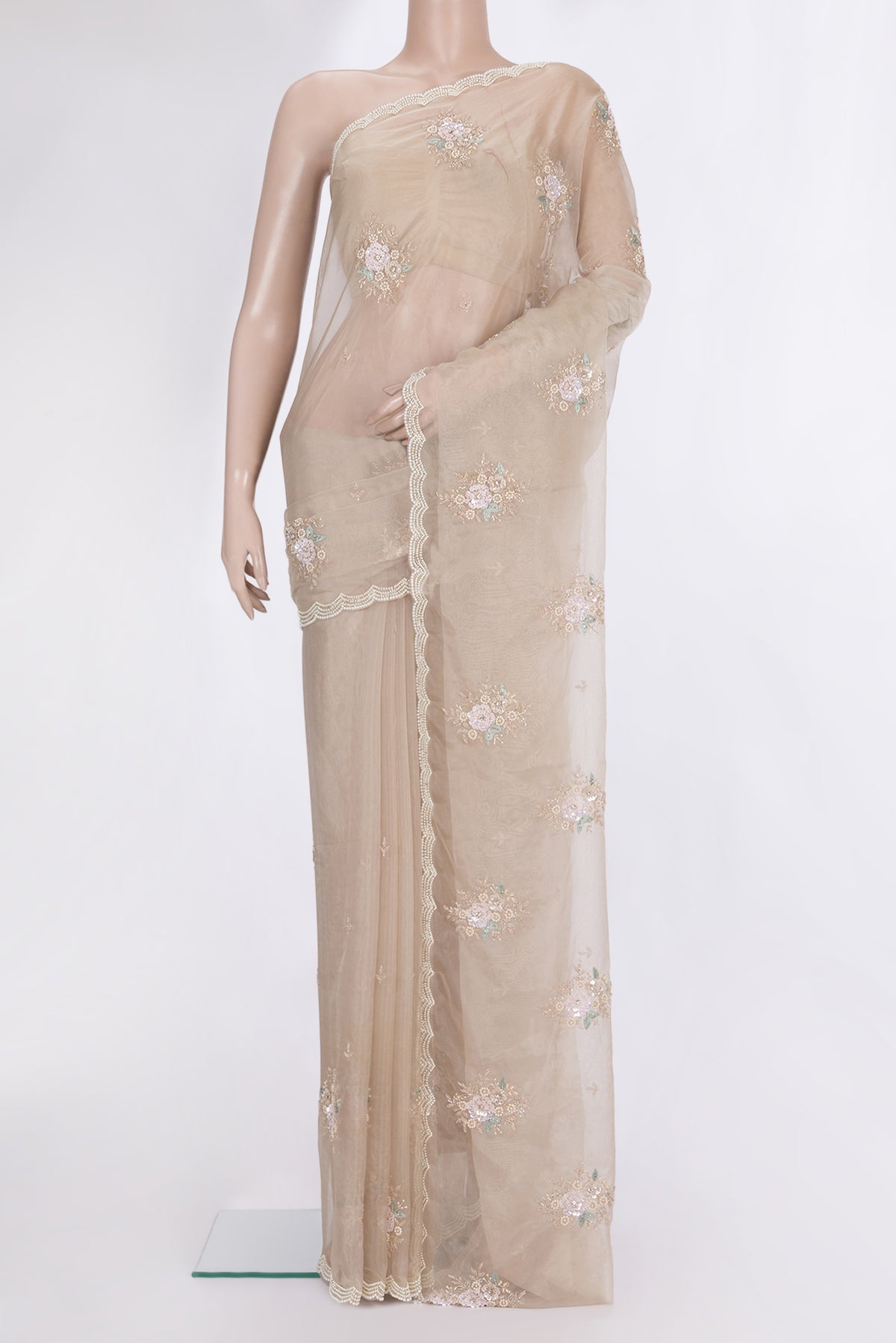 Beige Organza Saree with Embroidered on the body and Sequin Border.  displayed on a mannequin