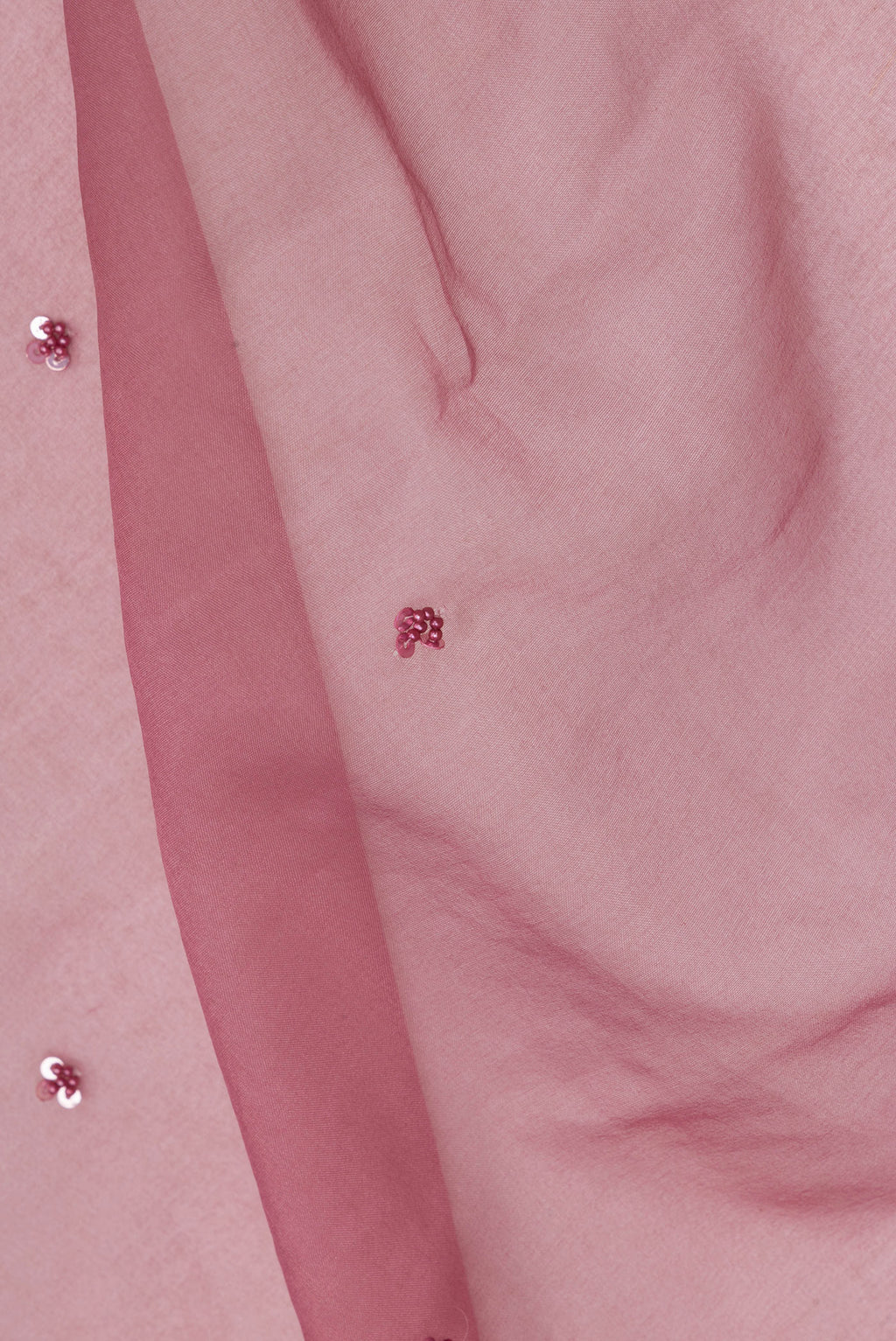 Close up of Mauve Organza Saree with Embroidered on the body and Embroidered Border.  displaying folds