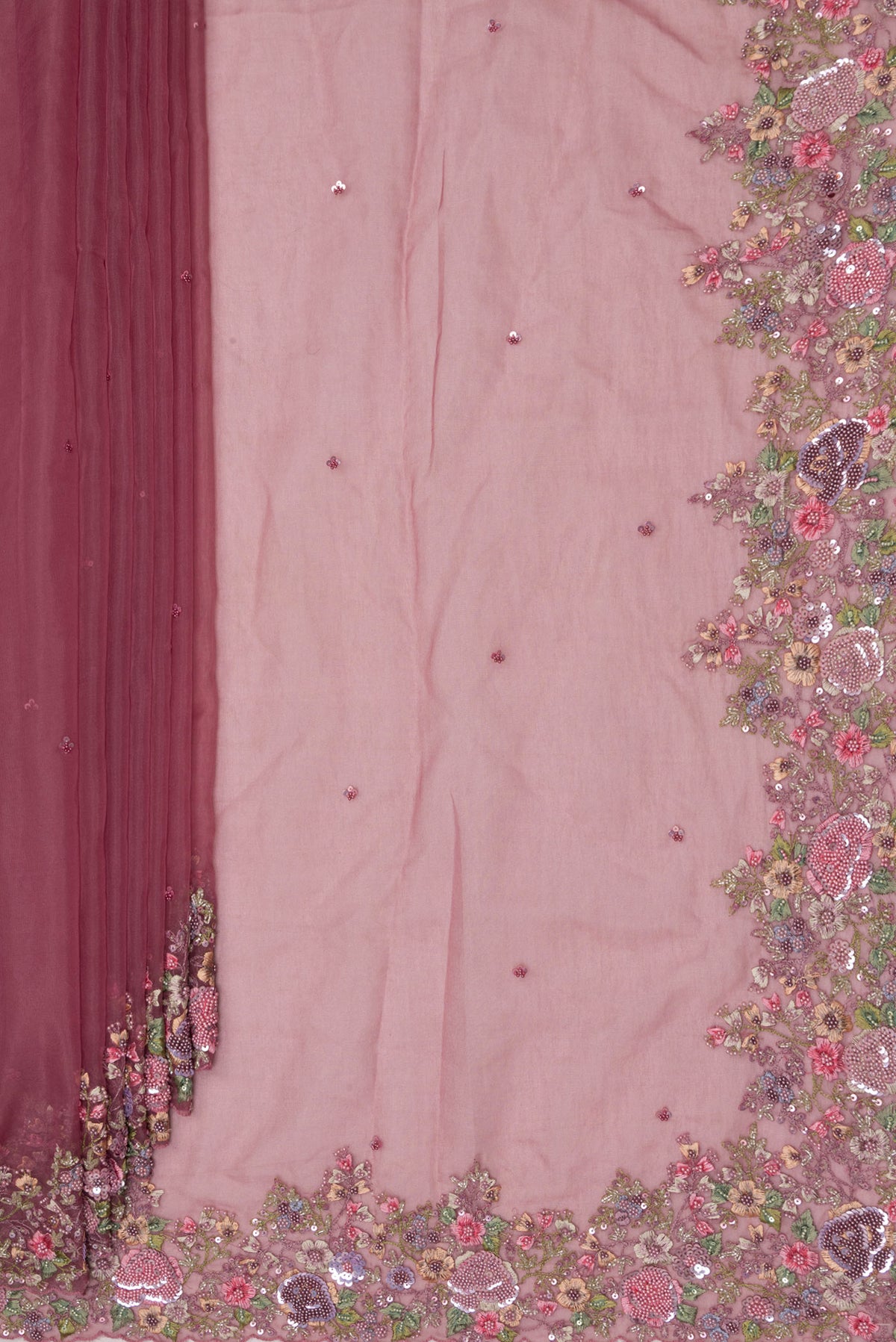 Pleats and pallu of Mauve Organza Saree with Embroidered on the body and Embroidered Border. 