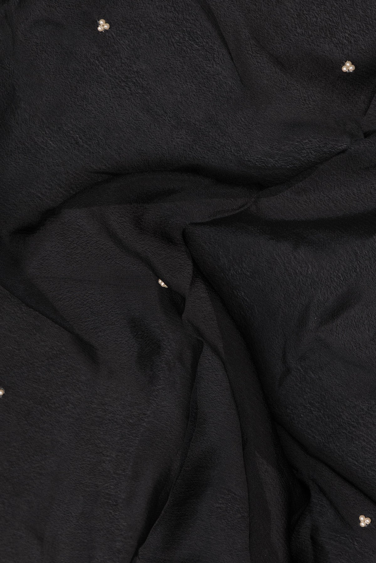 Close up of Black Crepe Saree with Embroidered on the body and Embroidered Border.  displaying folds
