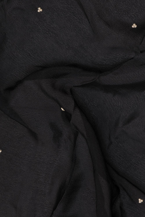 Close up of Black Crepe Saree with Embroidered on the body and Embroidered Border.  displaying folds