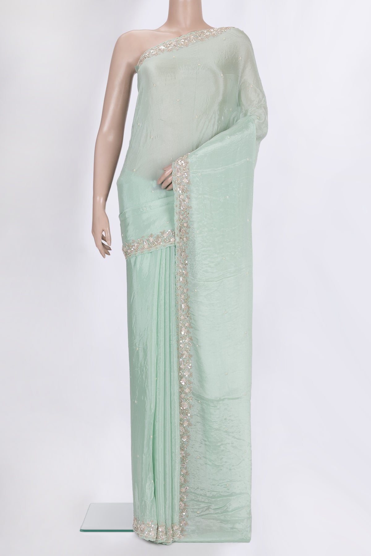 Mint Green Crepe Saree with Embroidered on the body and Sequin Border.  displayed on a mannequin