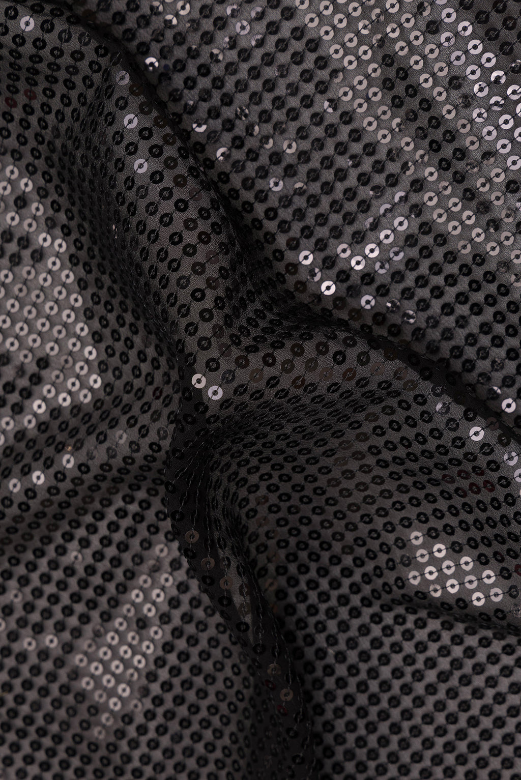 Close up of Black Georgette Saree with Embroidered on the body and Sequin Border.  displaying folds
