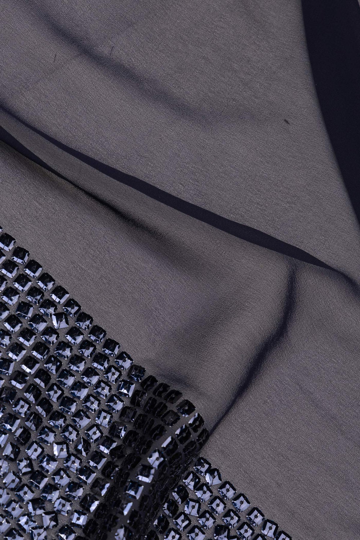 Close up of Navy Blue Georgette Saree with Embroidered on the body and Sequin Border.  displaying folds