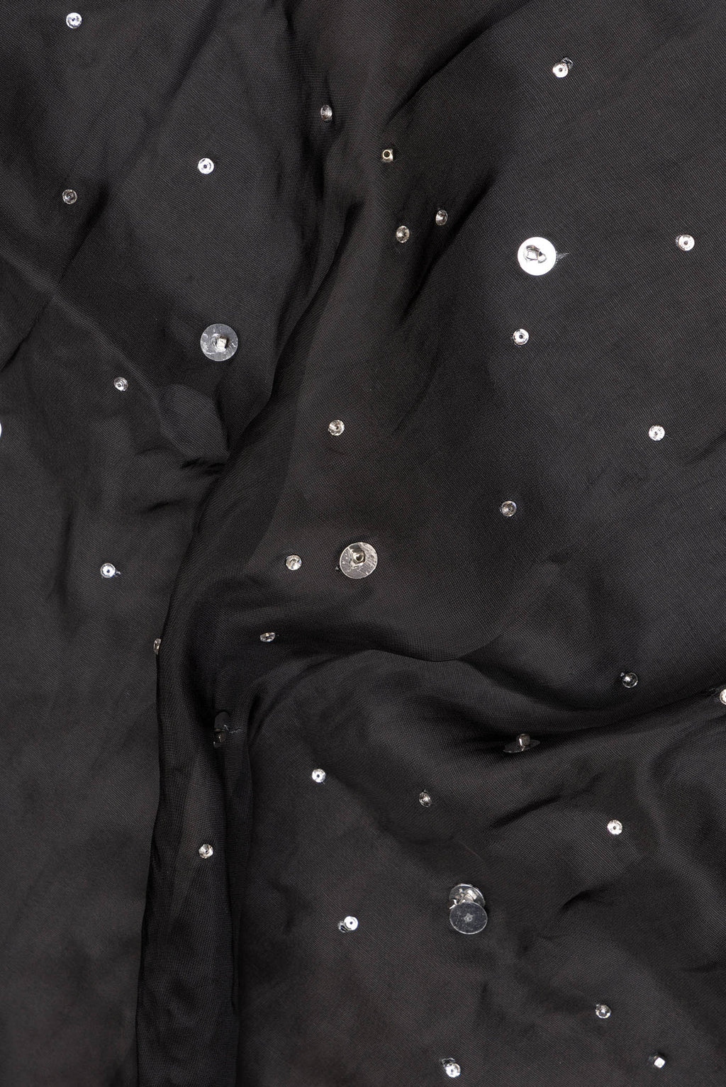 Close up of Black Crepe Saree with Embroidered on the body and Sequin Border.  displaying folds