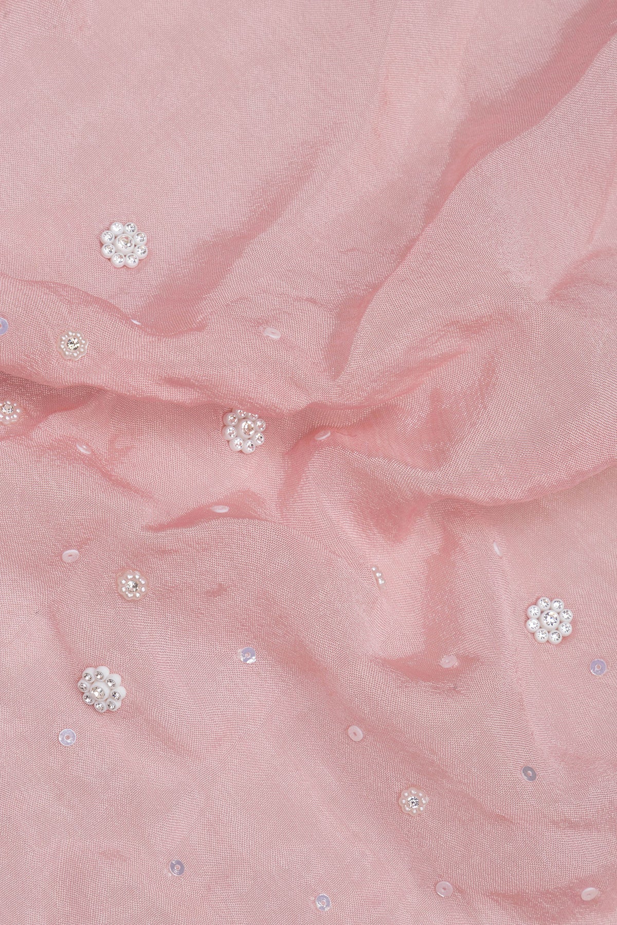 Close up of Pink Organza Saree with Embroidered on the body and Sequin Border.  displaying folds