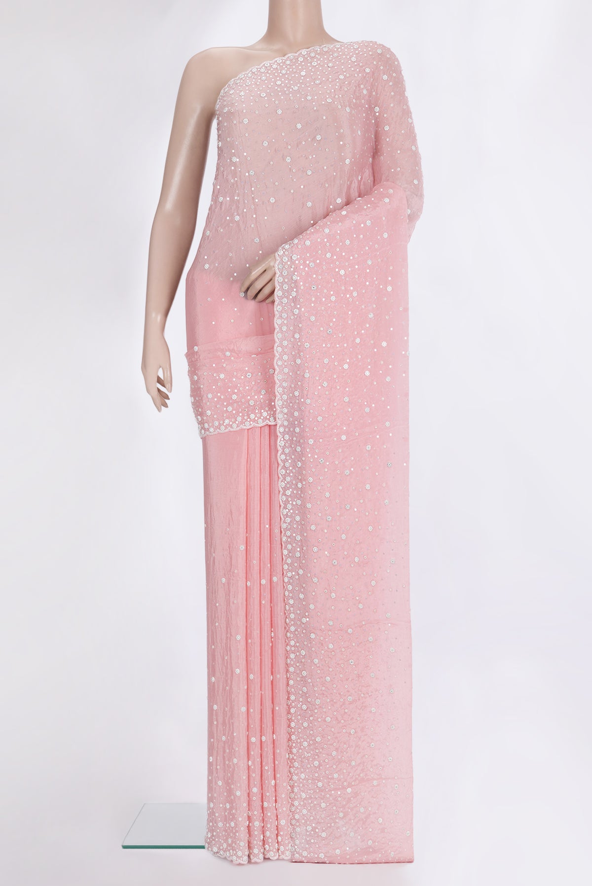 Pink Organza Saree with Embroidered on the body and Sequin Border.  displayed on a mannequin