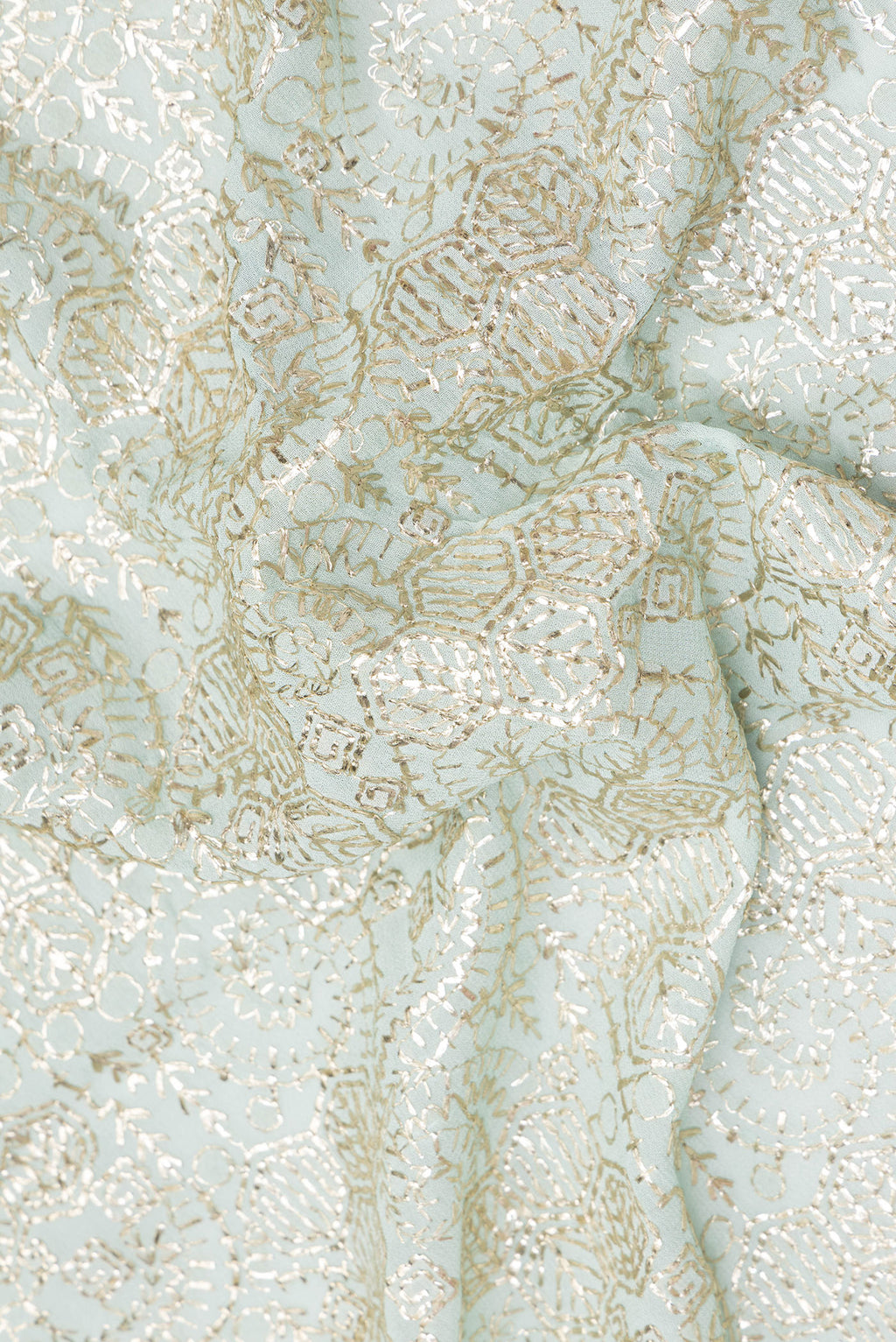 Close up of Light Blue Dual Tone Georgette Saree with Embroidery on the body and Sequin Border.  displaying folds