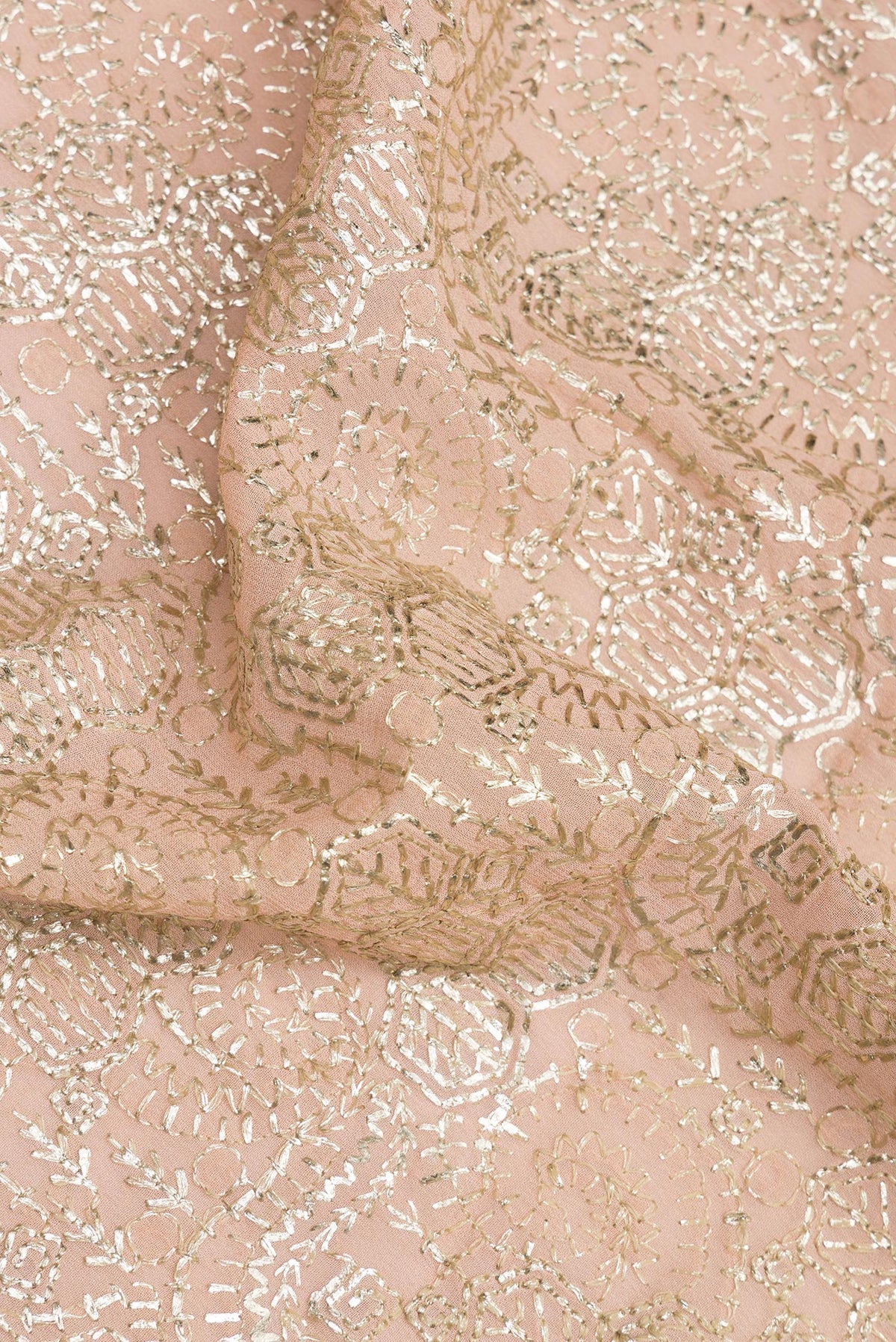Close up of Peach Dual Tone Georgette Saree with Embroidered on the body and Sequin Border.  displaying folds