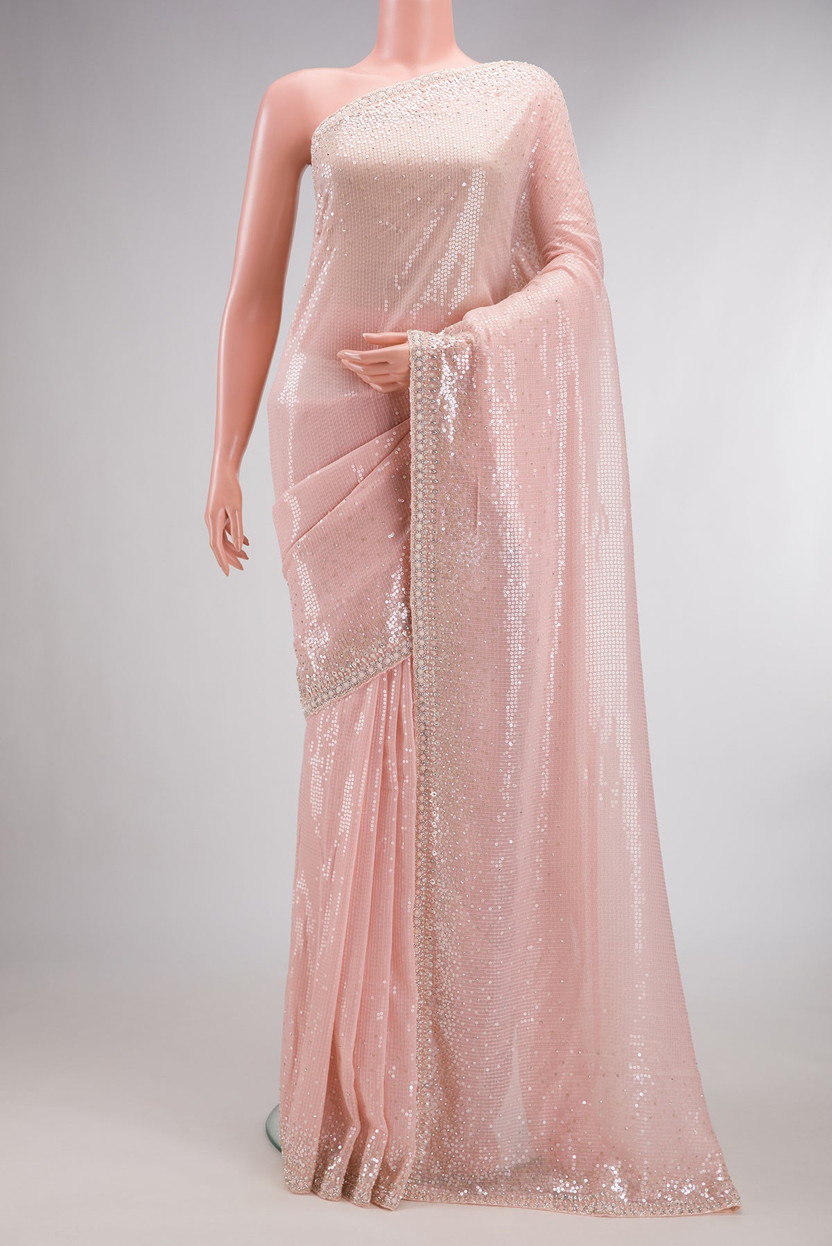 Golden Peach Georgette Saree with Embroidered on the body and Sequin Border.  displayed on a mannequin