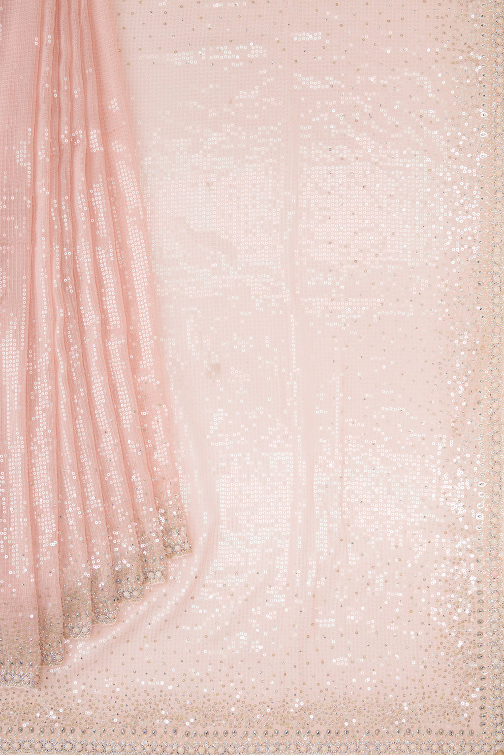 Pleats and pallu of Golden Peach Georgette Saree with Embroidered on the body and Sequin Border. 